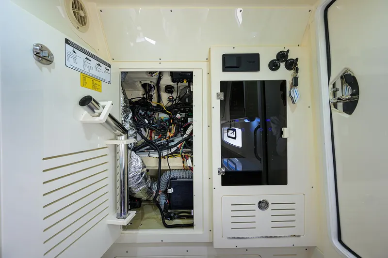 Slide: The Image of 2023 Scout 355 LXF boat interior showing electrical wiring and control panel. - 42