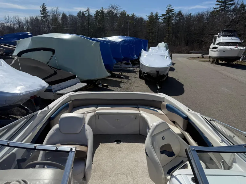 Slide: The Image of 1998 Four Winns 240 Horizon boat interior, parked among covered boats in a storage area. - 6