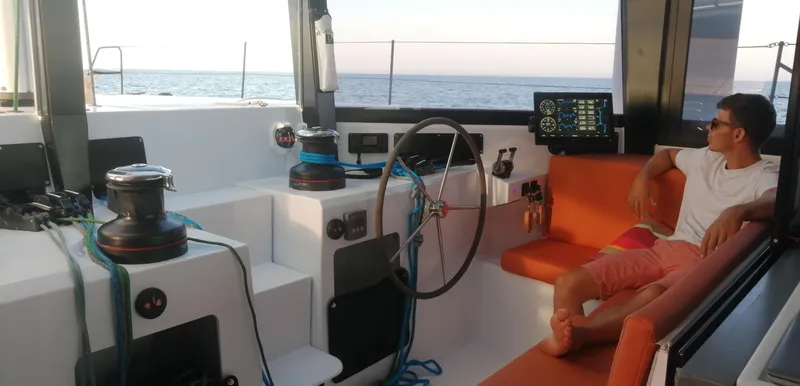 Slide: The Image of 2026 Windelo 50 Adventure yacht interior with person relaxing, featuring modern navigation equipment. - 5