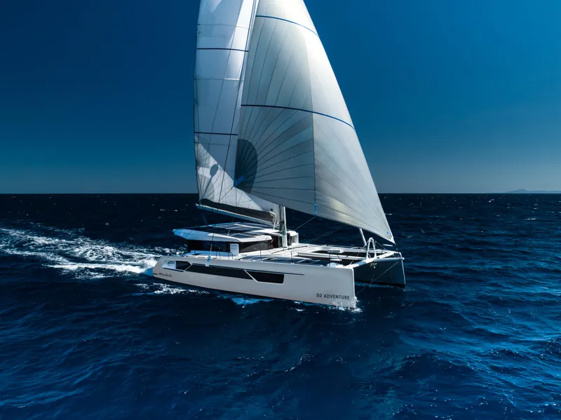 The Image of 2026 Windelo 50 Adventure catamaran sailing on open ocean under clear blue sky. - 0