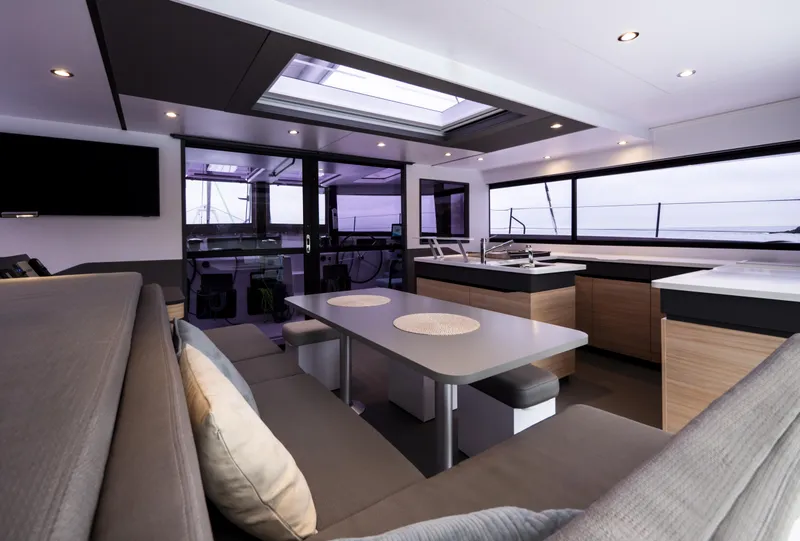 Slide: The Image of Luxurious interior of 2026 Windelo 50 Adventure catamaran with modern seating and dining area. - 25