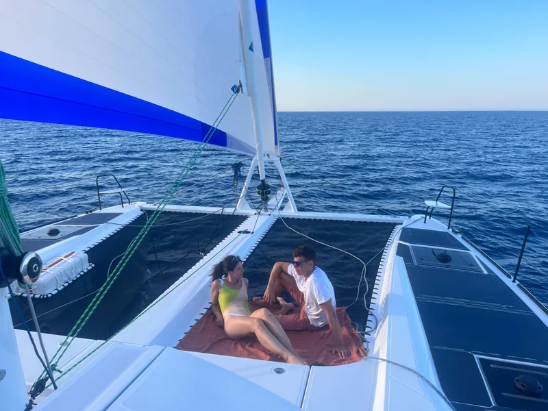 Slide: The Image of Couple relaxing on Windelo 50 Adventure catamaran, 2026 model, sailing on open sea. - 3