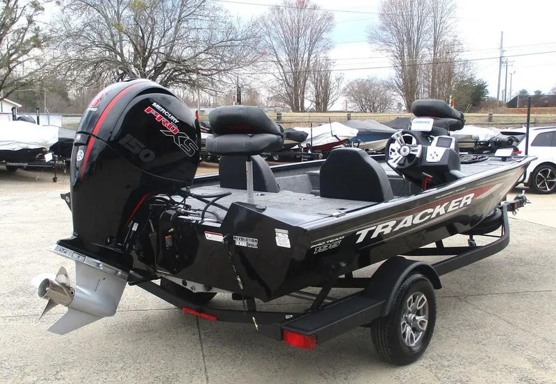 Slide: The Image of 2025 Tracker Pro Team™ 195 Tournament Edition boat with powerful engine, parked on trailer. - 3