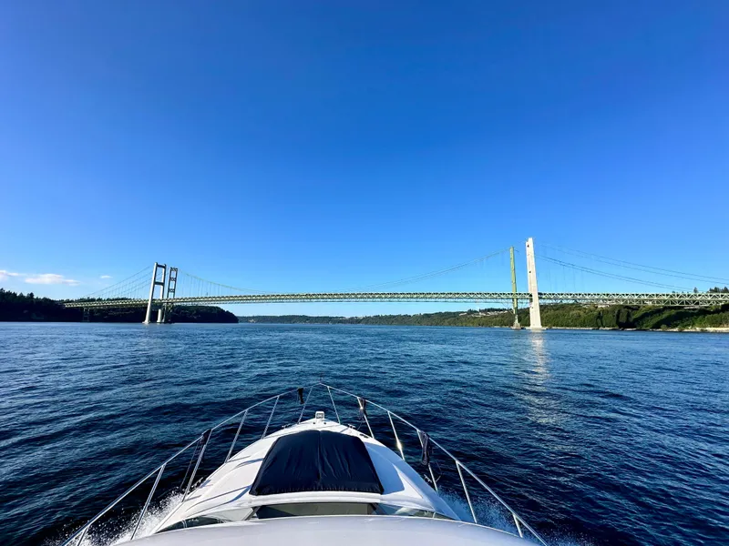 Slide: The Image of Luxurious Prima 5230 yacht interior with panoramic windows, wooden table, and scenic water view. - 12