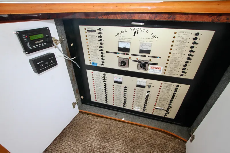 Slide: The Image of Electrical control panel of Prima Yachts Inc, model 5230, year 1999, with switches and meters. - 16