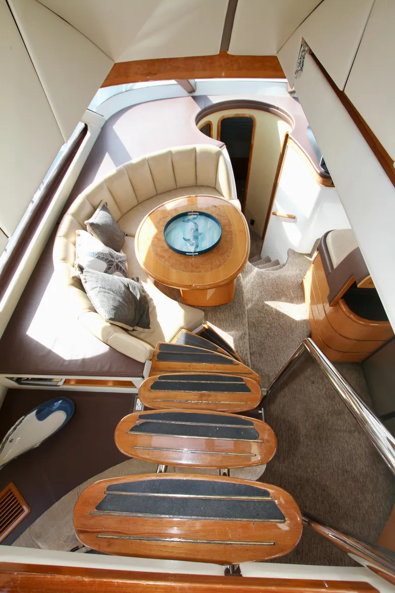 Slide: The Image of Interior view of a 1999 Prima 5230 boat with marina background. - 18