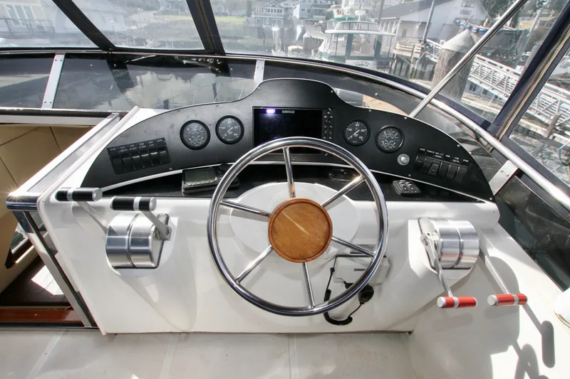 Slide: The Image of Interior of a 1999 Prima 5230 yacht with wooden stairs and cozy seating area. - 19