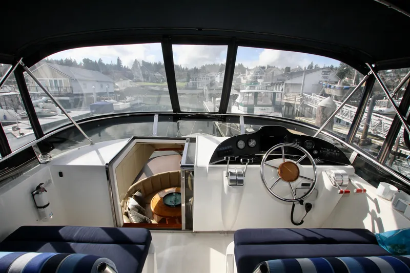 Slide: The Image of Boat cockpit with steering wheel and controls, Prima 5230, 1999 model, docked at marina. - 20