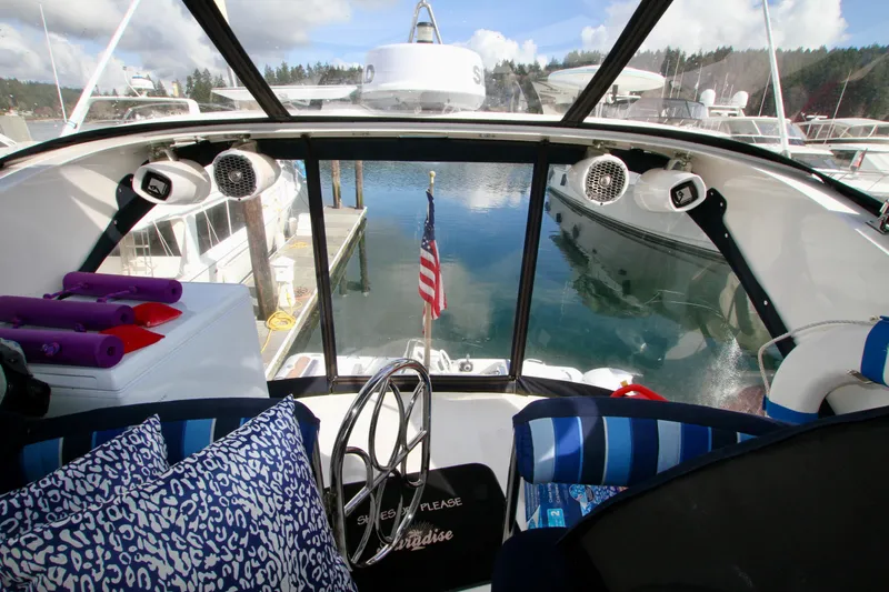 Slide: The Image of Interior view of a 1999 Prima 5230 boat with American flag and marina. - 22
