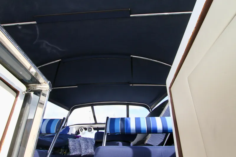Slide: The Image of Interior view of a 1999 Prima 5230 boat with blue canopy and seating. - 24