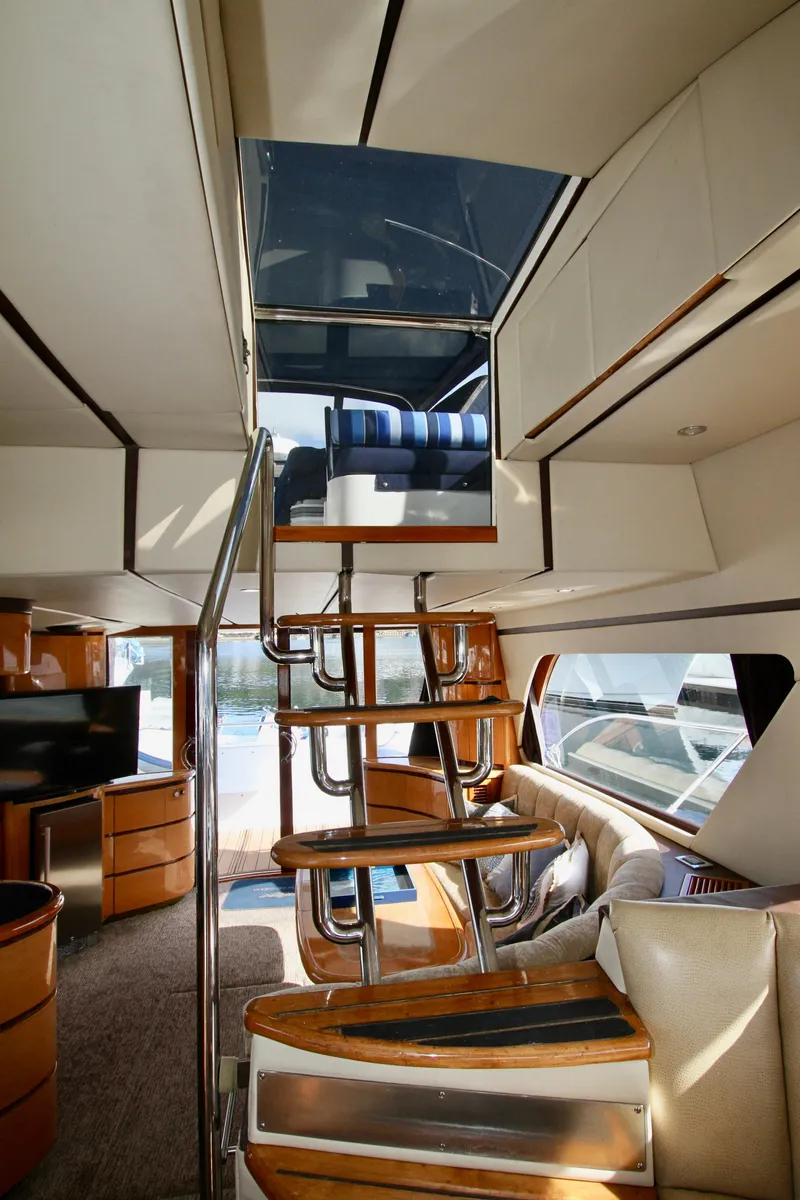 Slide: The Image of Interior view of a 1999 Prima 5230 boat with blue seating and canopy. - 26