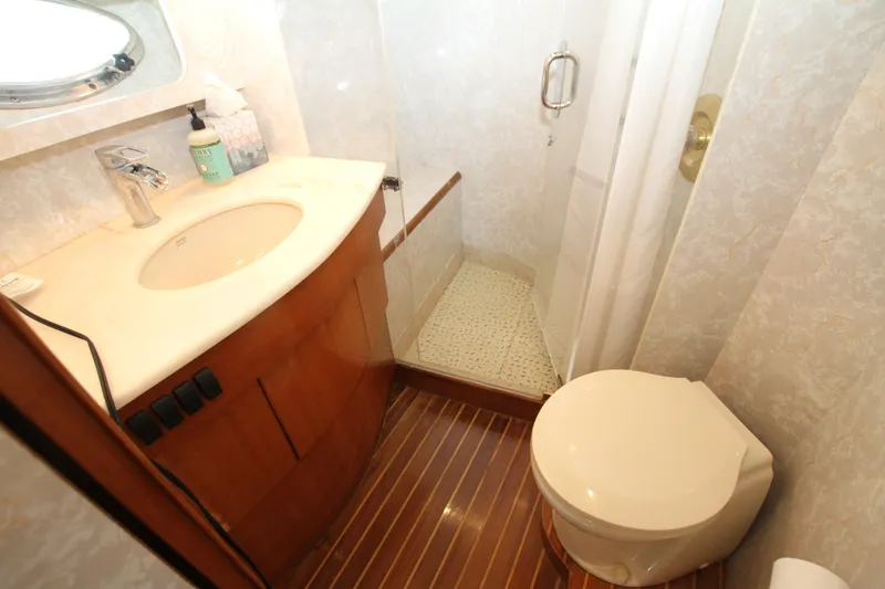 Slide: The Image of Luxurious yacht bathroom with wood accents, sink, and view into cozy bedroom. Prima 5230, 1999. - 32