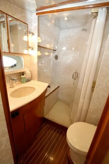 Slide: The Image of Compact shower with glass door and wooden accents in a Prima 5230, 1999 model. - 33