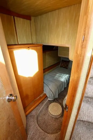 Slide: The Image of Luxurious cabin interior of a 1999 Prima 5230 yacht with elegant bedding and wood finish. - 38