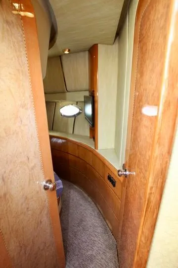 Slide: The Image of Cozy cabin interior of 1999 Prima 5230 boat with bed and wooden furnishings. - 40