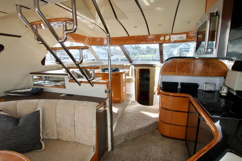 Slide: The Image of Luxurious yacht interior with curved seating, wooden table, and spiral staircase, Prima 5230, 1999 model. - 47