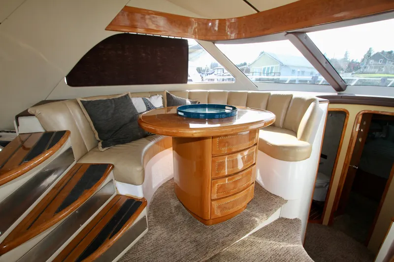 Slide: The Image of Luxurious Prima 5230 yacht interior, featuring elegant wood finishes and comfortable seating, 1999 model. - 48