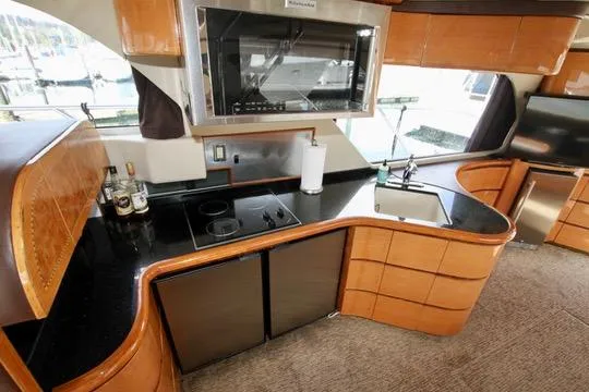 Slide: The Image of Luxurious Prima 5230 yacht interior with elegant seating and wooden table, 1999 model. - 51
