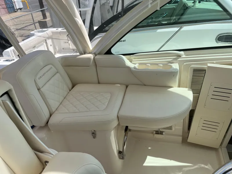 Slide: The Image of 2023 Grady-White Express 330 boat interior with luxurious white seating. - 10