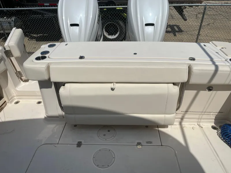 Slide: The Image of 2023 Grady-White Express 330 boat with dual outboard engines and spacious seating area. - 17