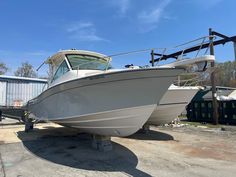 Slide: The Image of 2023 Grady-White Express 330 boat on dry dock under clear blue sky. - 2