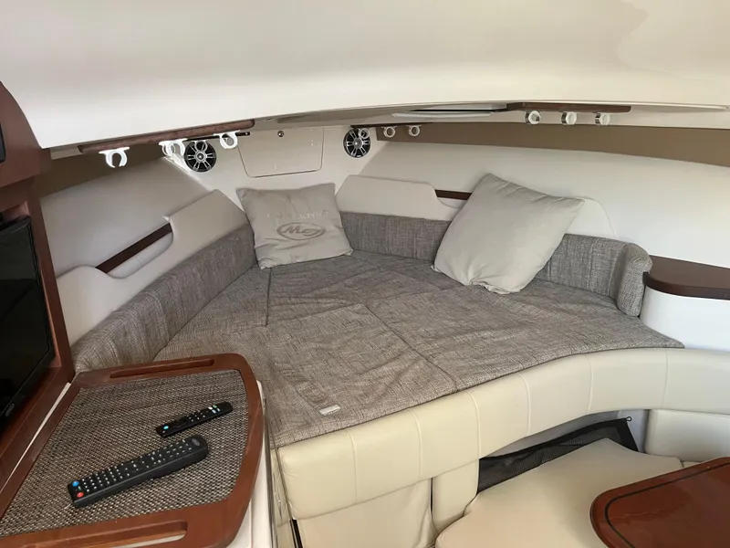 Slide: The Image of 2023 Grady-White Express 330 cabin interior with cozy bedding and modern amenities. - 23