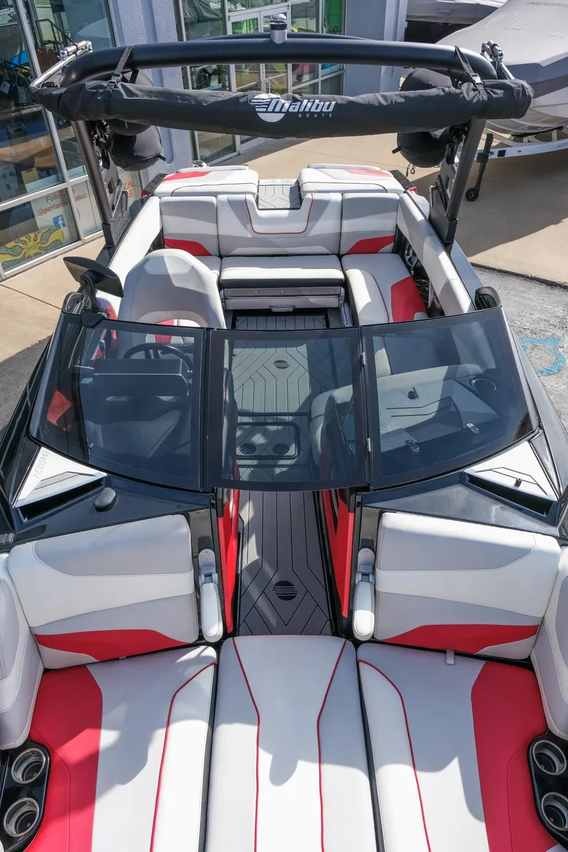 Slide: The Image of 2017 Malibu Wakesetter 22 MXZ boat interior with red and white seating. - 11