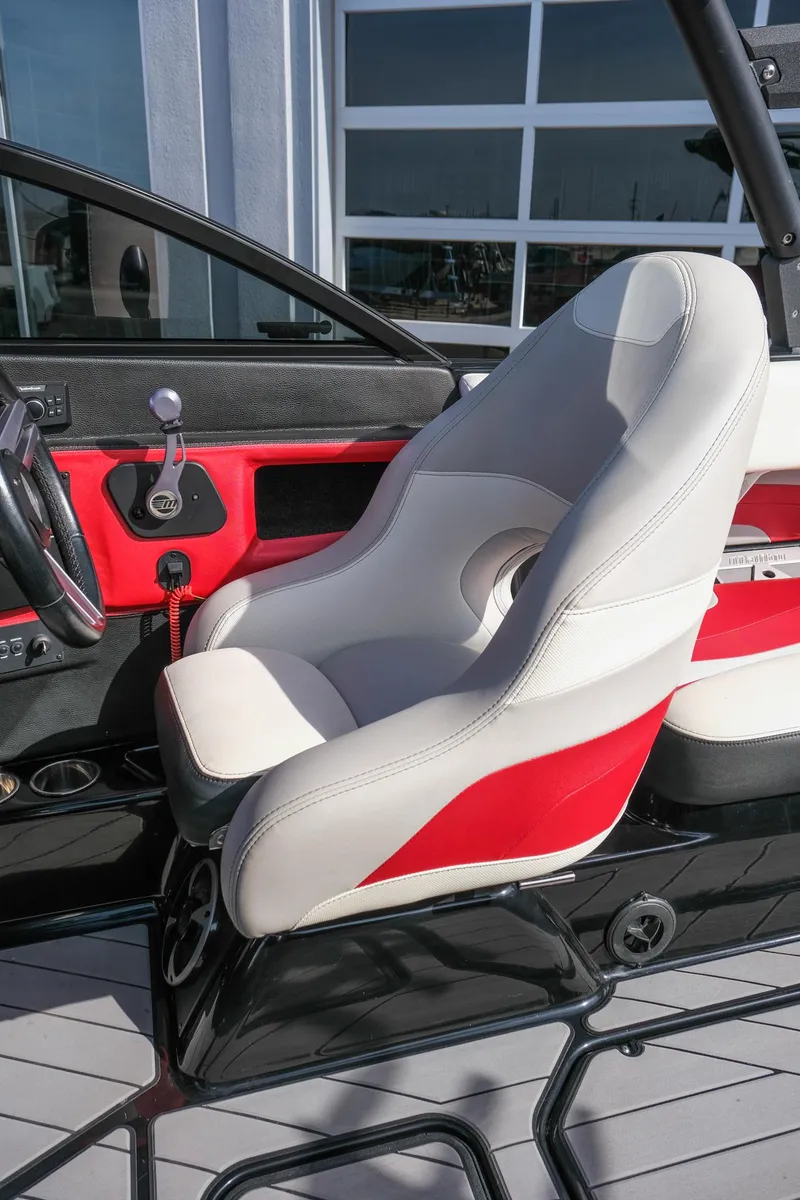 Slide: The Image of 2017 Malibu Wakesetter 22 MXZ boat interior with red and white seating. - 14