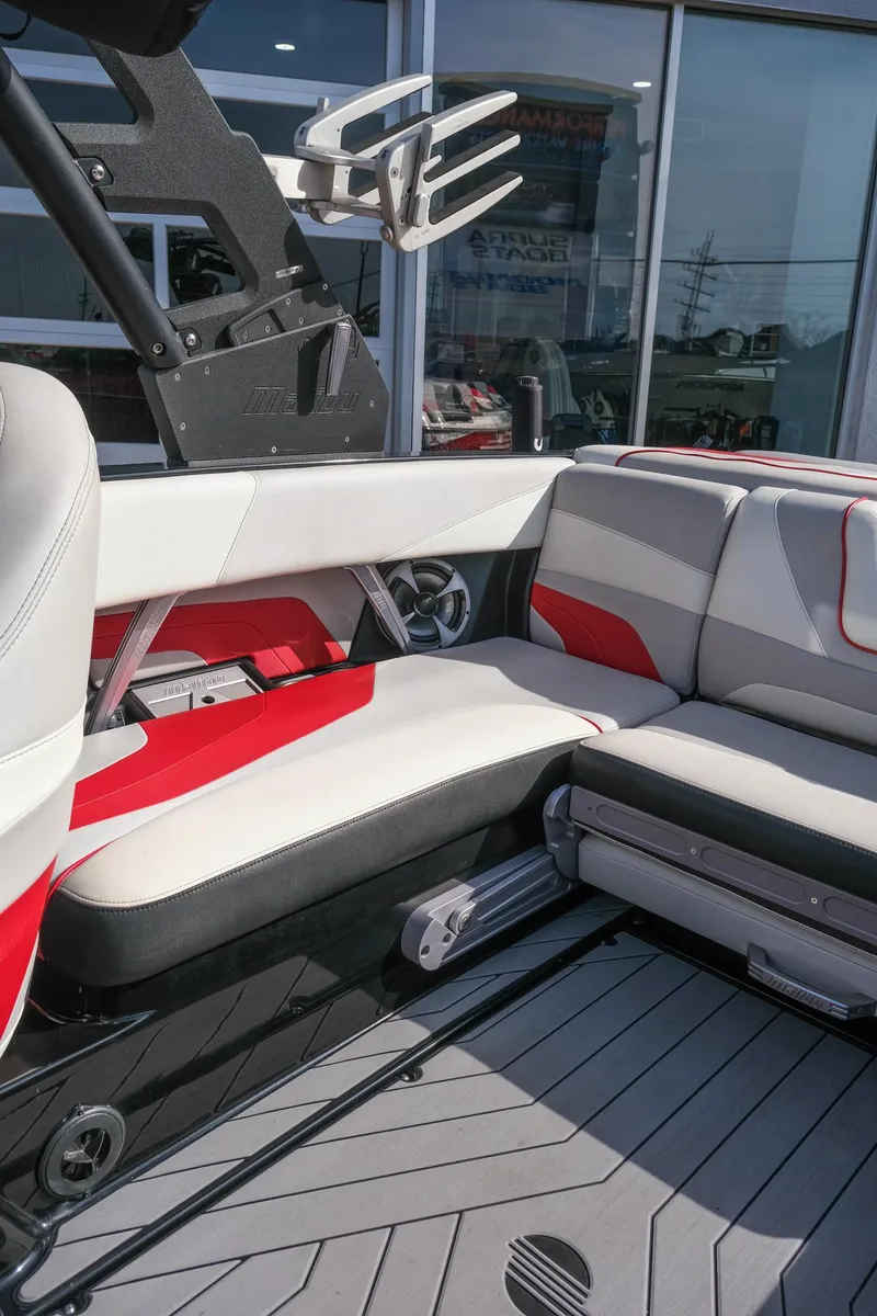 Slide: The Image of 2017 Malibu Wakesetter 22 MXZ interior with red and gray seating, showcasing modern design. - 15