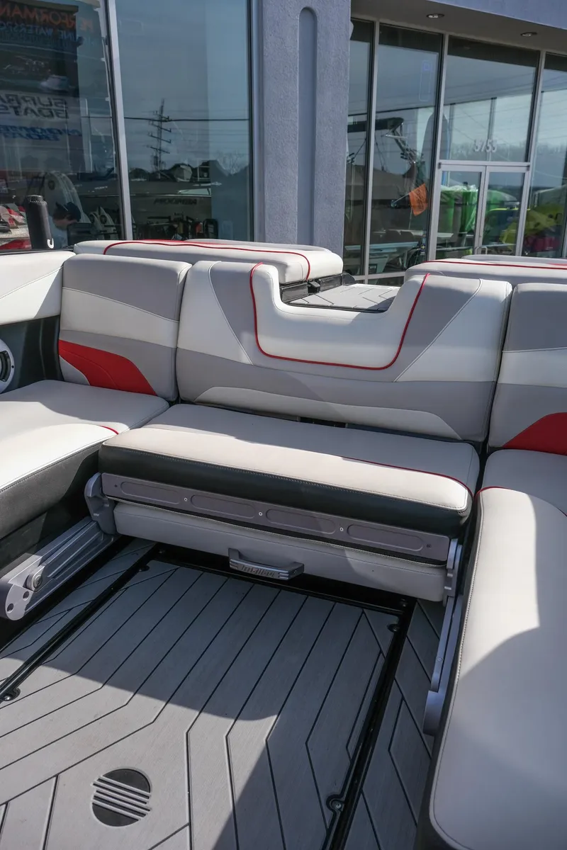 Slide: The Image of 2017 Malibu Wakesetter 22 MXZ interior with gray and red seating, modern design. - 16