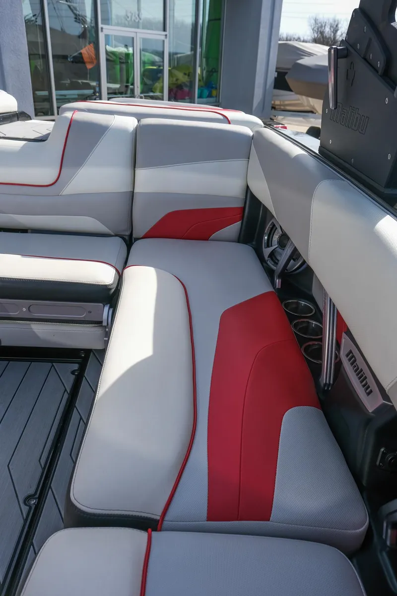 Slide: The Image of 2017 Malibu Wakesetter 22 MXZ interior with red and gray seating, showcasing modern design. - 17