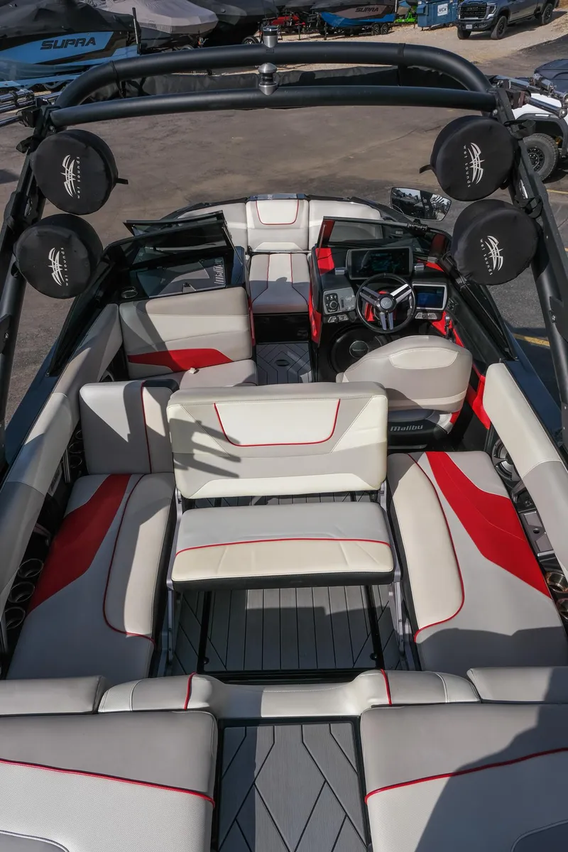 Slide: The Image of 2017 Malibu Wakesetter 22 MXZ interior with red accents and modern dashboard. - 23