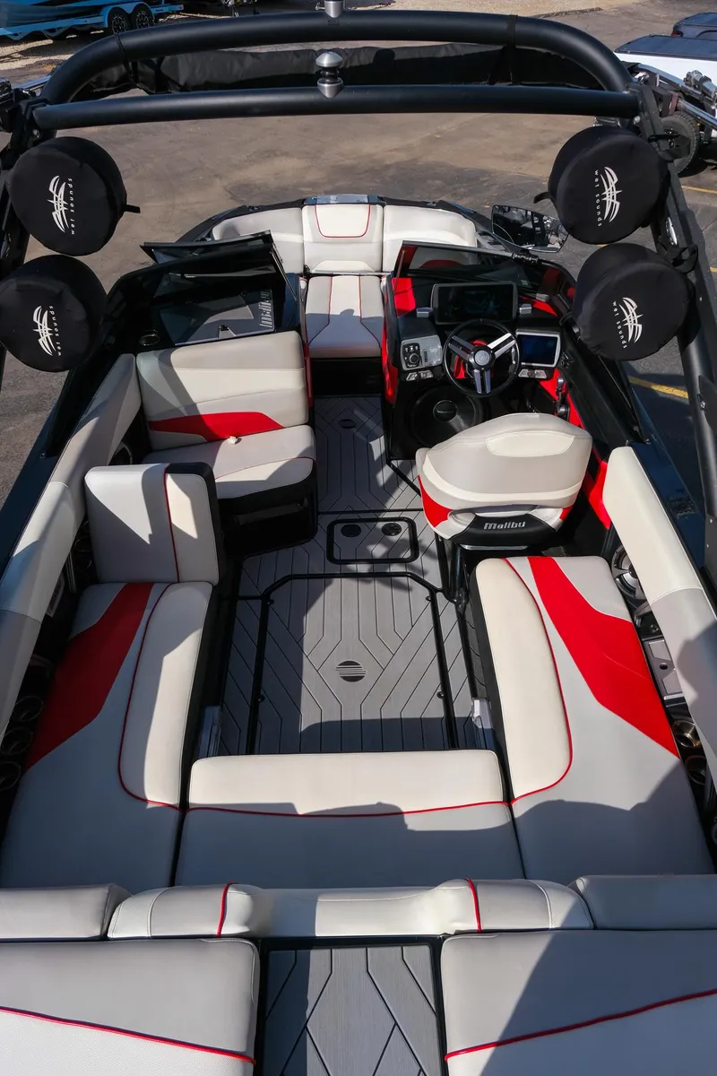 Slide: The Image of 2017 Malibu Wakesetter 22 MXZ interior with red and white seating, advanced dashboard, and spacious layout. - 27