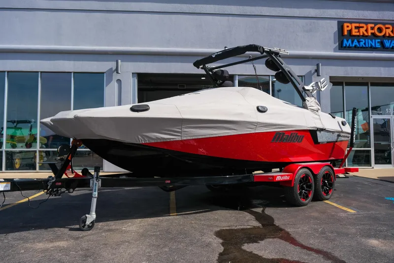Slide: The Image of 2017 Malibu Wakesetter 22 MXZ boat with cover on trailer, parked outside dealership. - 33