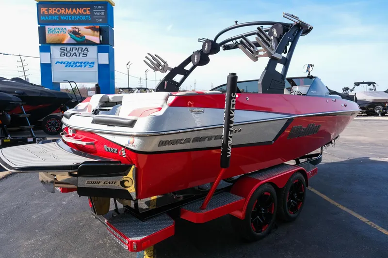 Slide: The Image of 2017 Malibu Wakesetter 22 MXZ boat in vibrant red on a trailer at a dealership. - 7