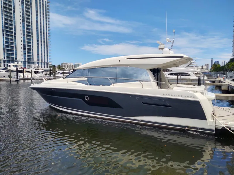 Slide: The Image of 2020 Prestige 520S yacht docked in marina, modern design, skyscrapers in background. - 1