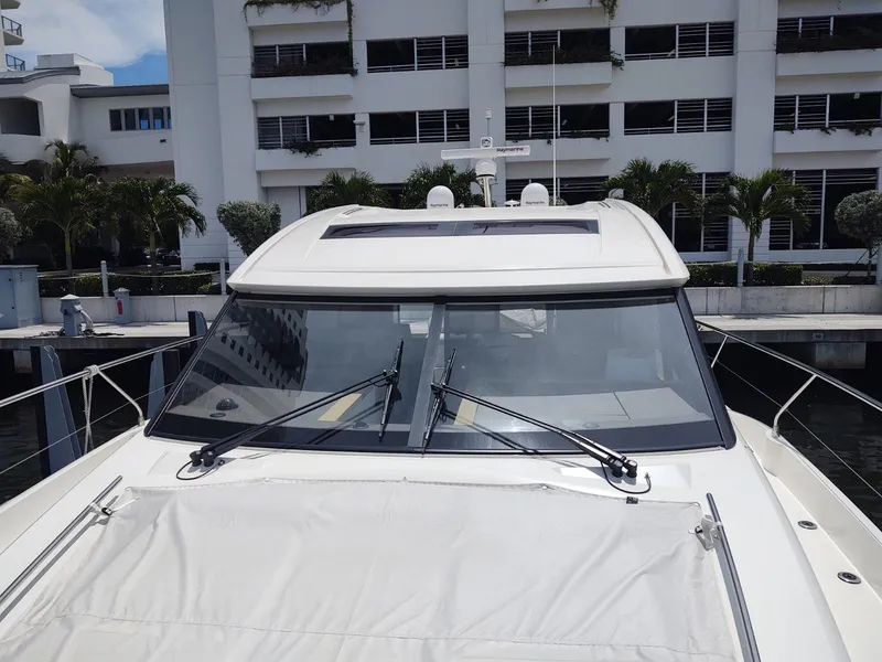 Slide: The Image of 2020 Prestige 520S yacht docked near modern waterfront building. - 13