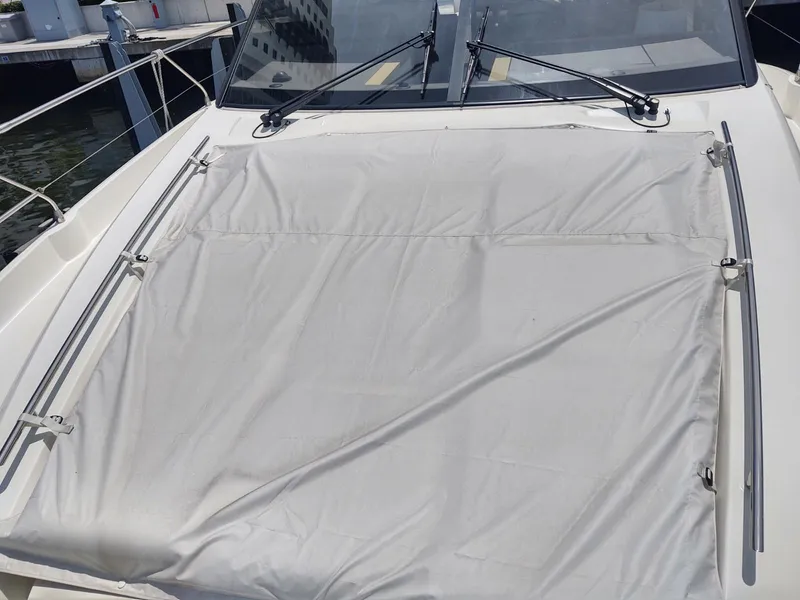 Slide: The Image of 2020 Prestige 520S yacht with covered deck area, docked at marina. - 14