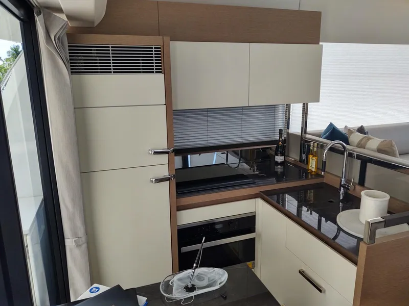 Slide: The Image of Modern kitchen interior of a 2020 Prestige 520S yacht, featuring sleek cabinetry and appliances. - 17