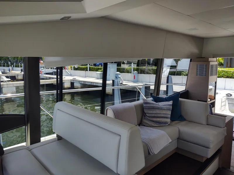 Slide: The Image of Interior of 2020 Prestige 520S yacht with modern seating and large windows. - 19