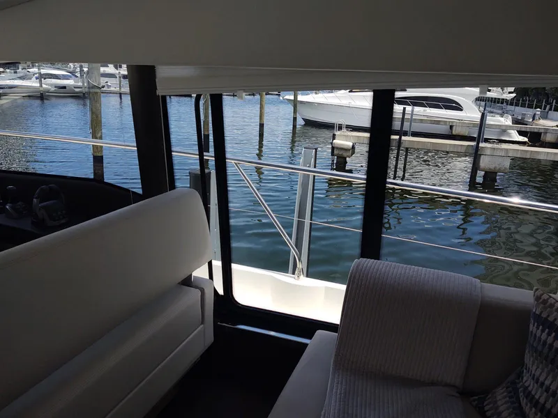 Slide: The Image of Interior view of a 2020 Prestige 520S yacht overlooking a marina. - 24