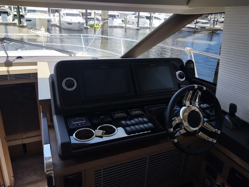 Slide: The Image of Helm of 2020 Prestige 520S yacht with dual screens and modern controls. - 26