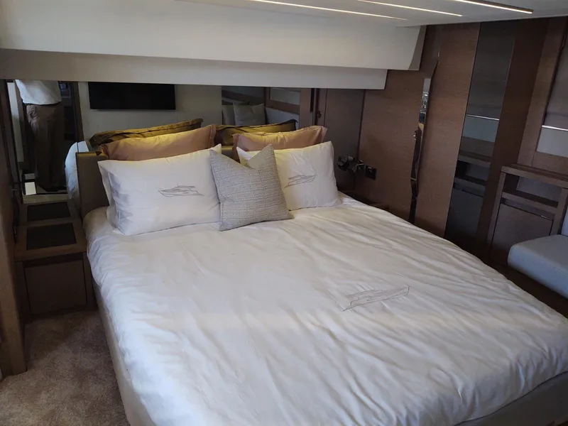 Slide: The Image of Luxurious bedroom interior of a 2020 Prestige 520S yacht with elegant bedding. - 28