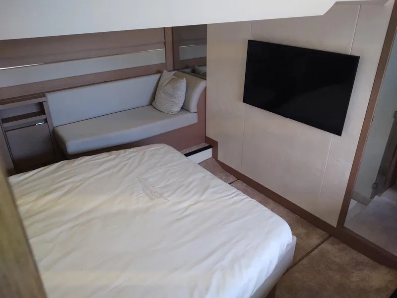 Slide: The Image of Luxurious cabin interior of 2020 Prestige 520S yacht with bed, sofa, and TV. - 29