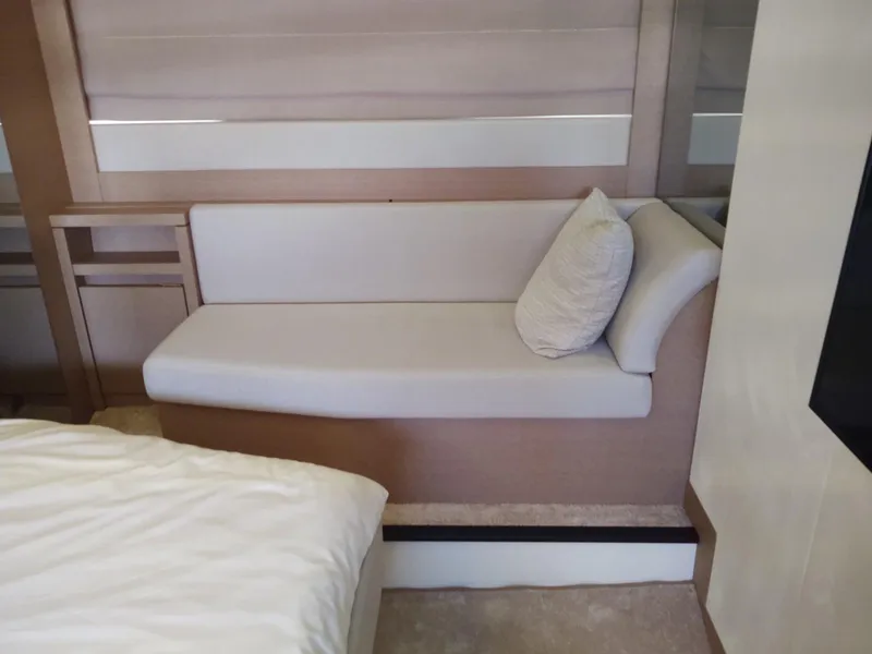 Slide: The Image of Modern interior of a 2020 Prestige 520S yacht with a sleek sofa and cushion. - 32