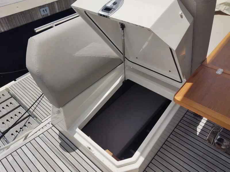 Slide: The Image of Open storage compartment on a 2020 Prestige 520S yacht, featuring sleek design and wood accents. - 38