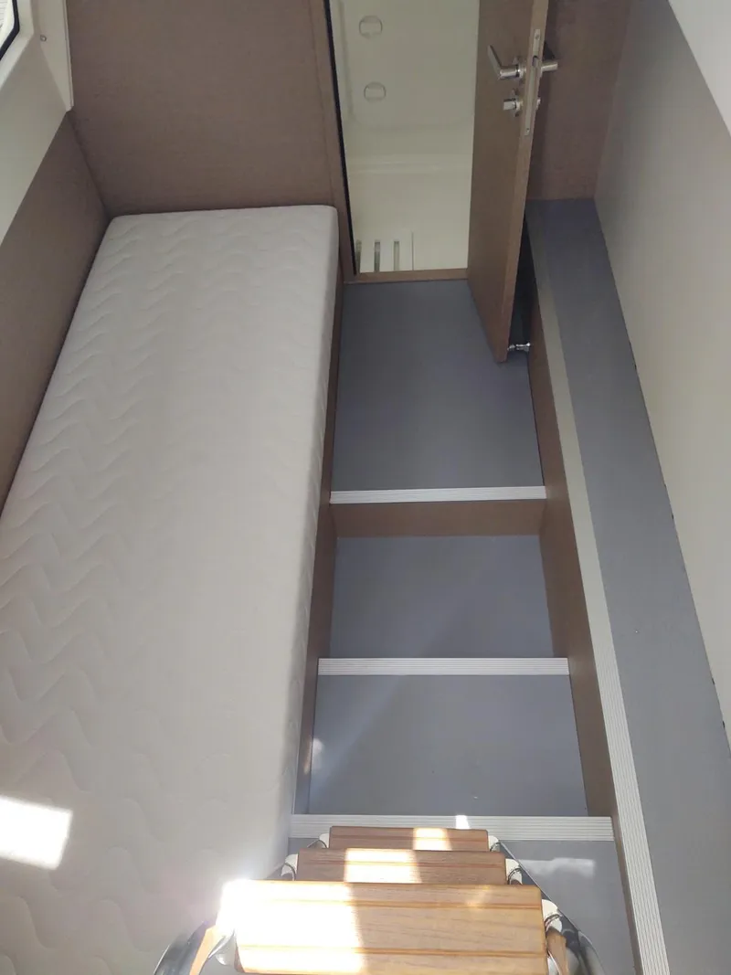 Slide: The Image of 2020 Prestige 520S yacht interior with stairs and mattress, showcasing modern design. - 39