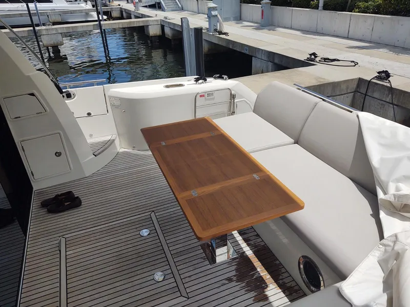 Slide: The Image of Luxury yacht Prestige 520S 2020 model, featuring elegant deck seating and wooden table. - 8