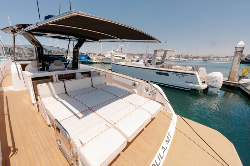 Slide: The Image of 2022 Pardo Yachts 38 docked at marina, showcasing sleek design and spacious deck. - 12