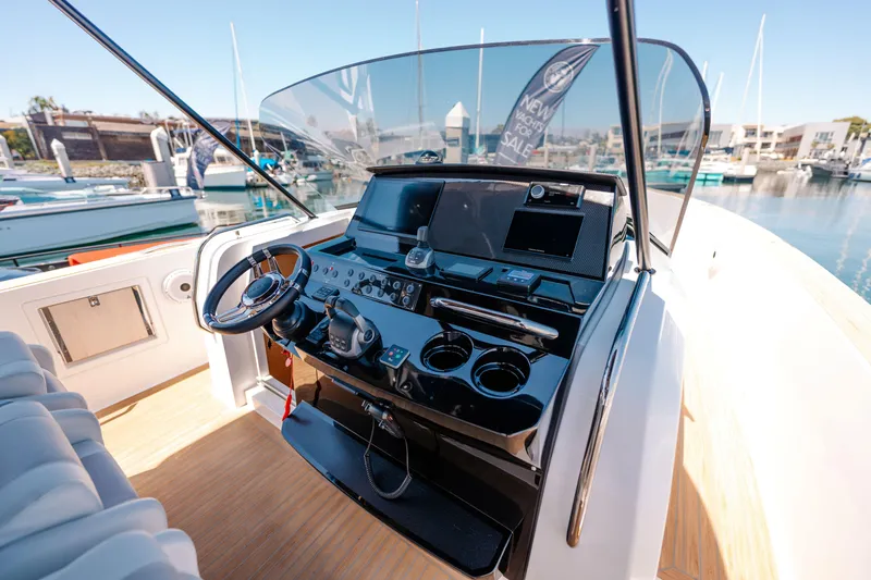 Slide: The Image of 2022 Pardo Yachts 38 helm with modern controls and marina view. - 25
